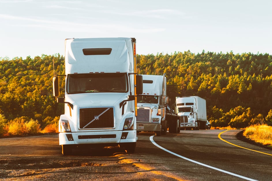 trucks driving on road